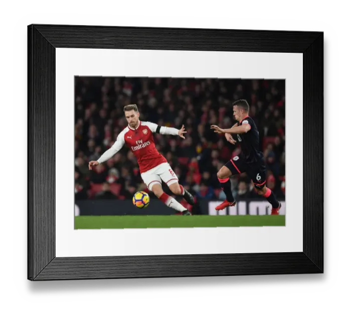 Framed Print : Arsenal's Aaron Ramsey Outmaneuvers Huddersfield's Jonathan Hogg in Premier League Clash Framed Print : Arsenal's Aaron Ramsey Outmaneuvers Huddersfield's Jonathan Hogg in Premier League Clash