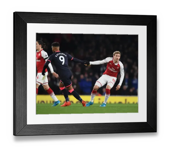 Framed Print : Monreal vs Kachunga: Intense Battle at Emirates Stadium (Arsenal v Huddersfield Town, 2017-18)