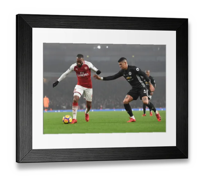 Framed Print : Arsenal's Alex Lacazette Clashes with Manchester United's Marcos Rojo in Premier League Showdown Framed Print : Arsenal's Alex Lacazette Clashes with Manchester United's Marcos Rojo in Premier League Showdown