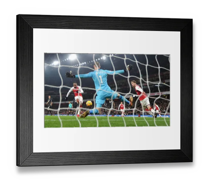 Framed Print : Lacazette Stuns Man Utd: Premier League Showdown - Arsenal's Star Forward Scores Past De Gea