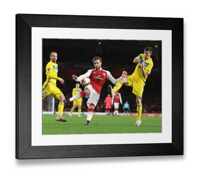 Framed Print : Clash at Emirates: Chambers vs. Stasevich in Arsenal's Europa League Battle Framed Print : Clash at Emirates: Chambers vs. Stasevich in Arsenal's Europa League Battle