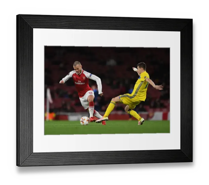 Framed Print : Jack Wilshere vs. Aleksei Rios: A Europa League Showdown at Arsenal's Emirates Stadium Framed Print : Jack Wilshere vs. Aleksei Rios: A Europa League Showdown at Arsenal's Emirates Stadium