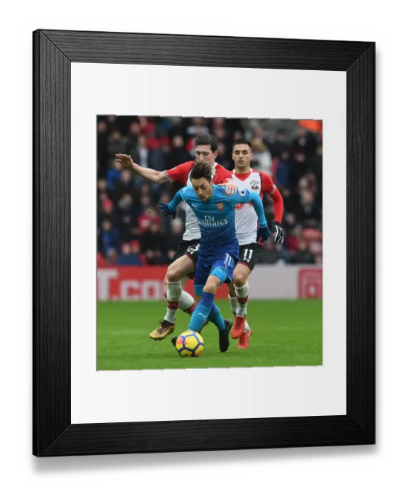 Framed Print : Mesut Ozil vs. Pierre-Emile Hojbjerg: Clash at St. Mary's Stadium - Southampton v Arsenal, Premier League 2017-18