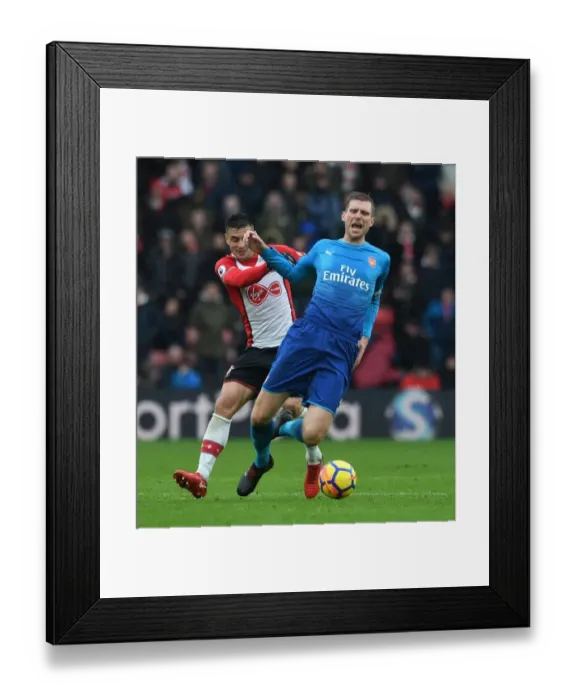 Framed Print : Per Mertesacker vs. Dusan Tadic: Intense Battle in Southampton v Arsenal Premier League Clash