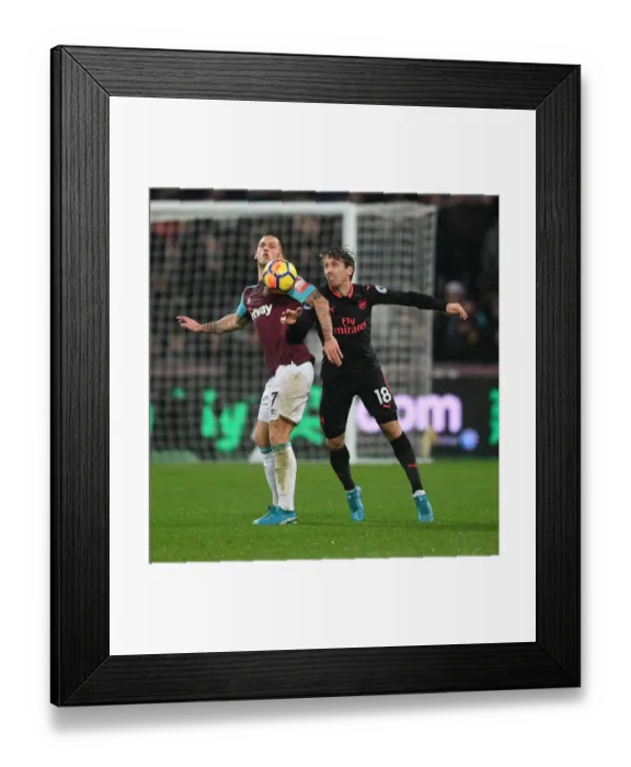 Framed Print : Clash at London Stadium: Monreal vs Arnautovic - Premier League Showdown Framed Print : Clash at London Stadium: Monreal vs Arnautovic - Premier League Showdown