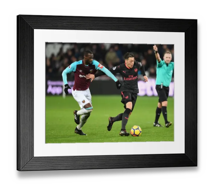 Framed Print : Mesut Ozil vs Pedro Obiang: A Battle in the Heart of the Premier League Clash between Arsenal and West Ham