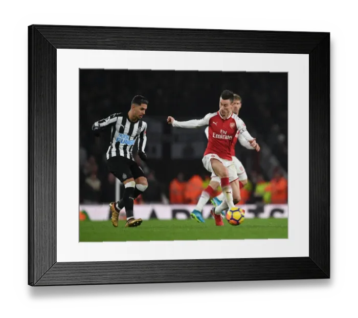 Framed Print : Clash of Titans: Koscielny vs. Perez in Arsenal's Battle Against Newcastle