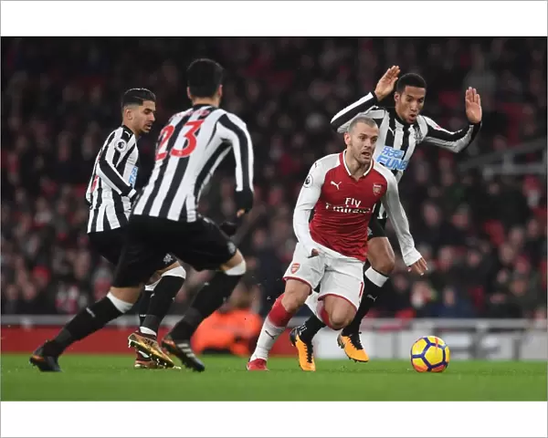 Arsenal's Jack Wilshere Clashes with Newcastle's Midfield Trio during Premier League Match