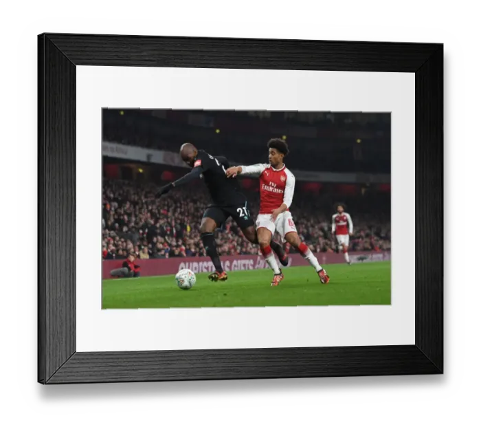 Framed Print : Reiss Nelson vs Angelo Ogbonna: Intense Battle in Arsenal's Carabao Cup Quarterfinal Against West Ham