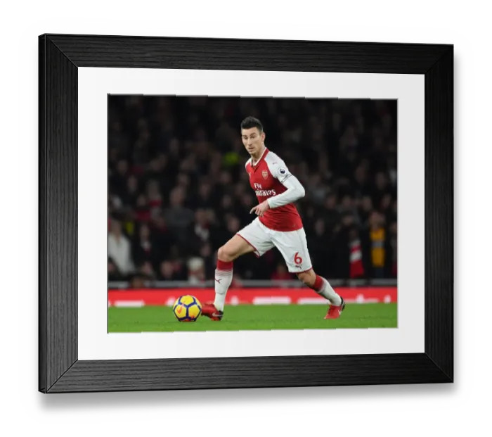 Framed Print : Arsenal vs. Liverpool: Koscielny's Intense Showdown in the Premier League