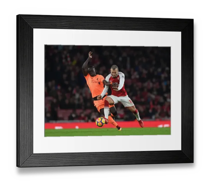 Framed Print : Clash of Talents: Wilshere vs Mane in Arsenal vs Liverpool Showdown
