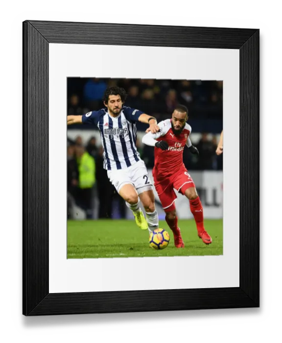 Framed Print : Arsenal's Alex Lacazette Clashes with West Brom's Ahmed Hegazi in Premier League Showdown