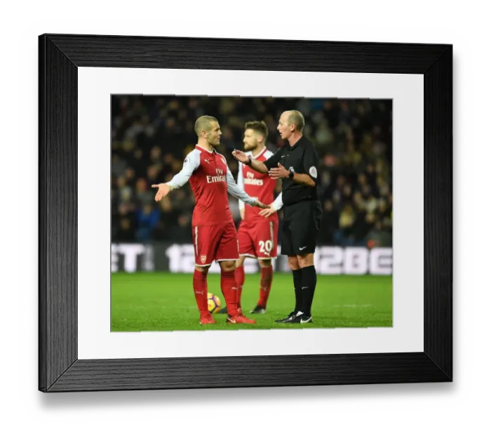 Framed Print : Jack Wilshere vs Mike Dean: Heated Confrontation during Arsenal's Match at West Bromwich Albion