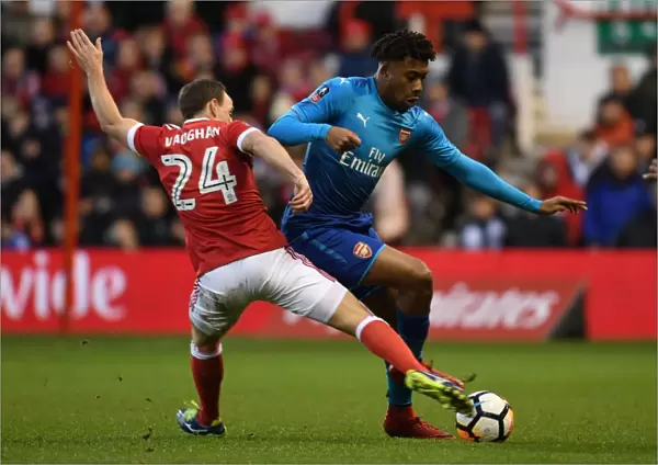 Arsenal's Alex Iwobi Outmaneuvers Nottingham Forest's David Vaughan in FA Cup Clash