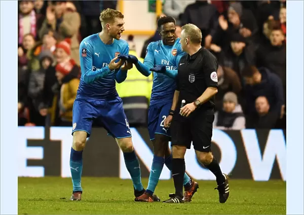 Arsenal's Per Mertesacker and Danny Welbeck Protest Referee's Call during FA Cup Match vs Nottingham Forest