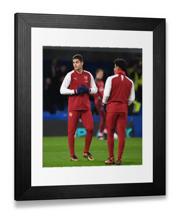 Framed Print : Arsenal Substitutes Mavropano and Nelson Warm Up Ahead of Chelsea Showdown - Carabao Cup Semi-Final