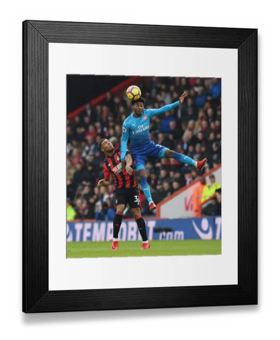 Framed Print : Ainsley Maitland-Niles Leaps Over Jordan Ibe in AFC Bournemouth vs Arsenal Premier League Clash Framed Print : Ainsley Maitland-Niles Leaps Over Jordan Ibe in AFC Bournemouth vs Arsenal Premier League Clash