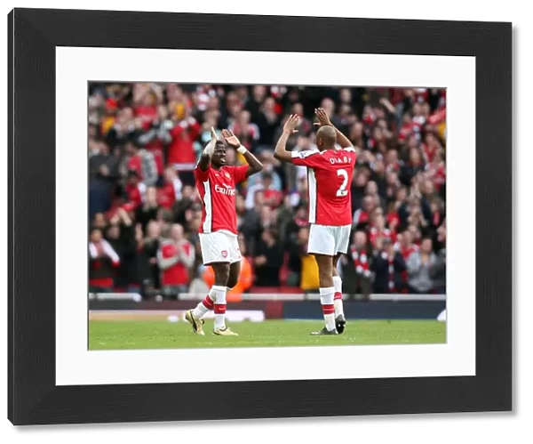 Emmanuel Eboue celebrates at the end of the match with Abou Diaby