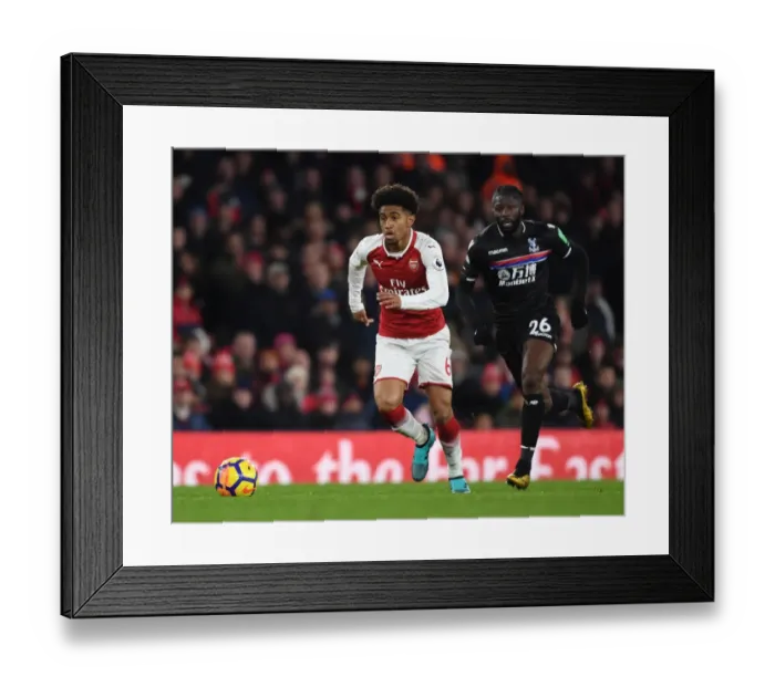 Framed Print : Arsenal's Reiss Nelson Outmaneuvers Crystal Palace's Bakary Sako