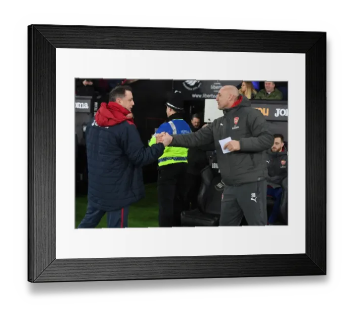 Framed Print : Steve Bould and Tony Roberts Exchange Handshakes Before Swansea City vs Arsenal (2017-18)