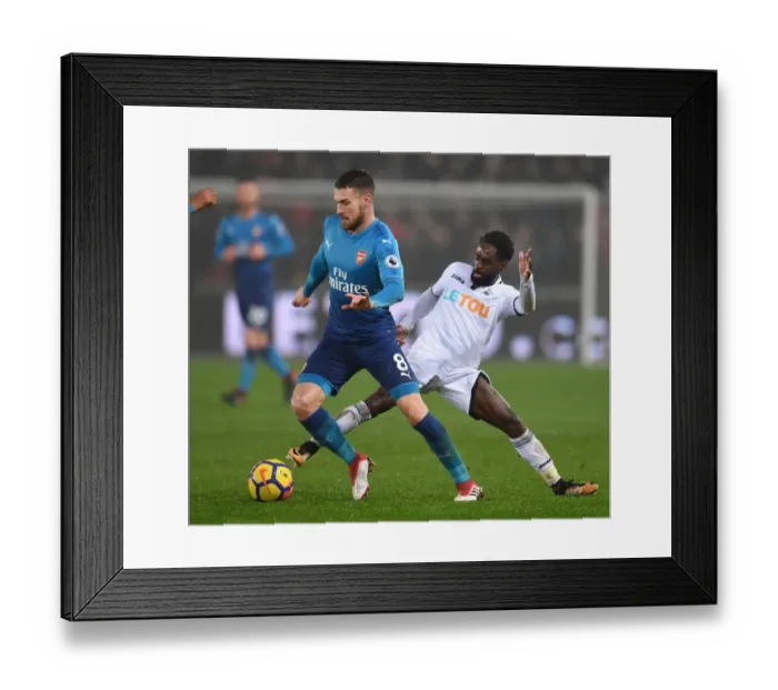 Framed Print : Arsenal's Aaron Ramsey Faces Off Against Swansea's Nathan Dyer in Premier League Clash Framed Print : Arsenal's Aaron Ramsey Faces Off Against Swansea's Nathan Dyer in Premier League Clash