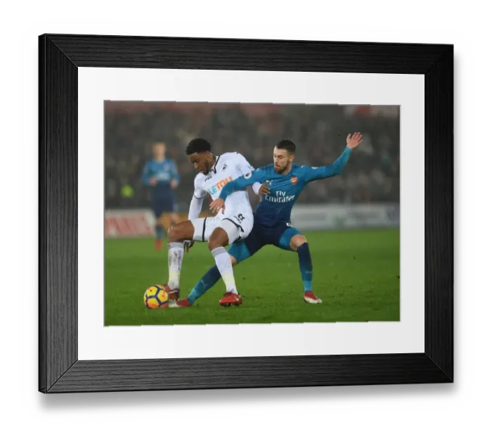 Framed Print : Aaron Ramsey vs. Leroy Fer: Intense Tackle in Swansea City vs. Arsenal Premier League Clash Framed Print : Aaron Ramsey vs. Leroy Fer: Intense Tackle in Swansea City vs. Arsenal Premier League Clash