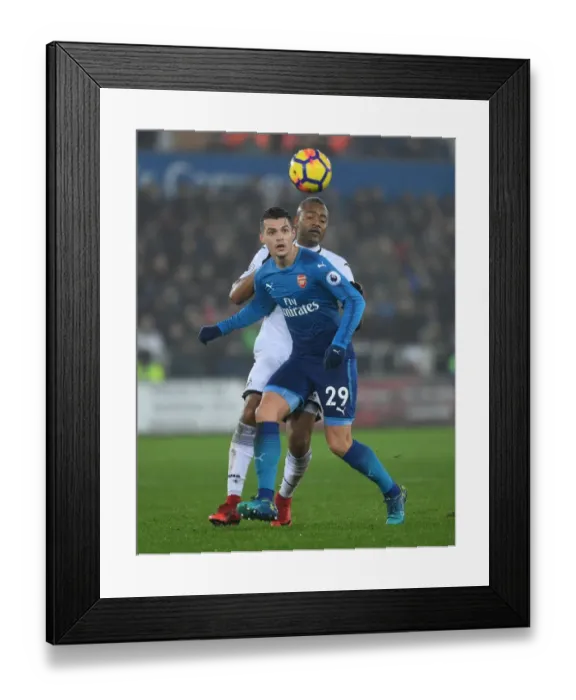 Framed Print : Xhaka vs Ayew: Intense Battle in Swansea City vs Arsenal Premier League Clash