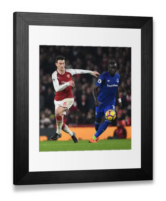 Framed Print : Arsenal's Laurent Koscielny Clashes with Everton's Oumar Niasse in Premier League Showdown Framed Print : Arsenal's Laurent Koscielny Clashes with Everton's Oumar Niasse in Premier League Showdown