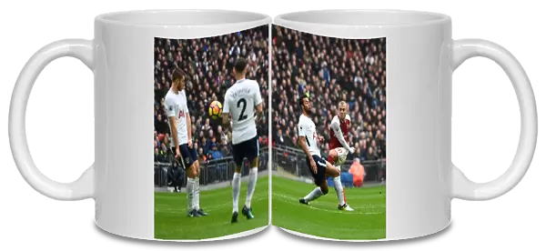 Jack Wilshere (Arsenal) shoots under pressure from Mousa Dembele (Tottenham)