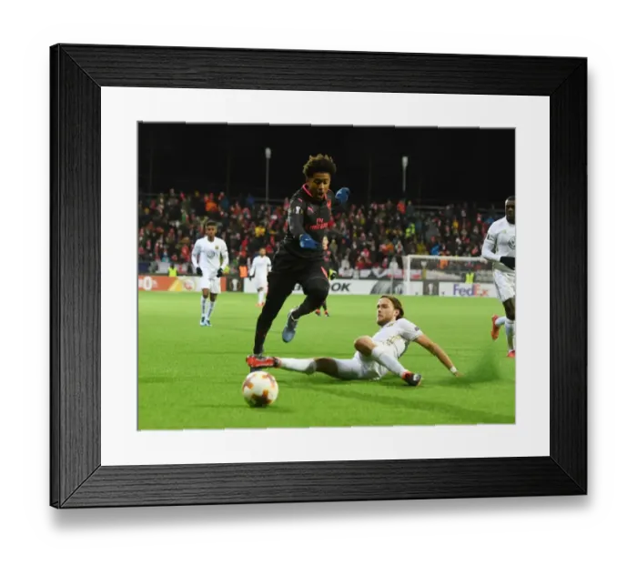 Framed Print : Reiss Nelson vs Tom Pettersson: Battle in the Europa League between Ostersunds and Arsenal