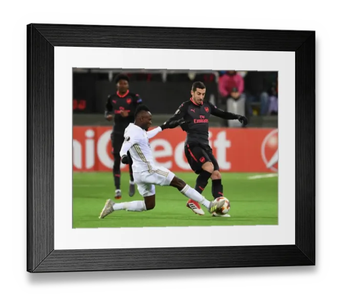 Framed Print : Mkhitaryan vs. Mensah: Intense Clash in Arsenal's Europa League Match against Ostersunds Framed Print : Mkhitaryan vs. Mensah: Intense Clash in Arsenal's Europa League Match against Ostersunds