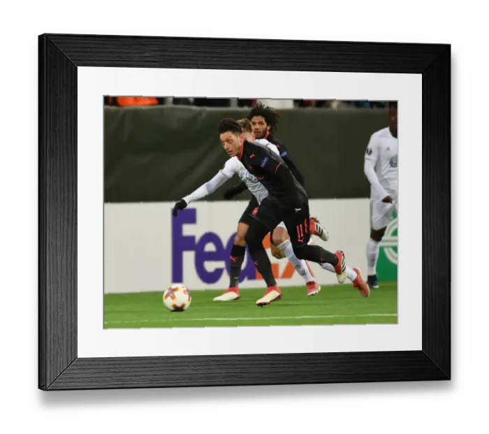 Framed Print : Mesut Ozil vs Dennis Widgren: A Battle of Midfield Maestros in Arsenal's Europa League Clash against Ostersunds FK
