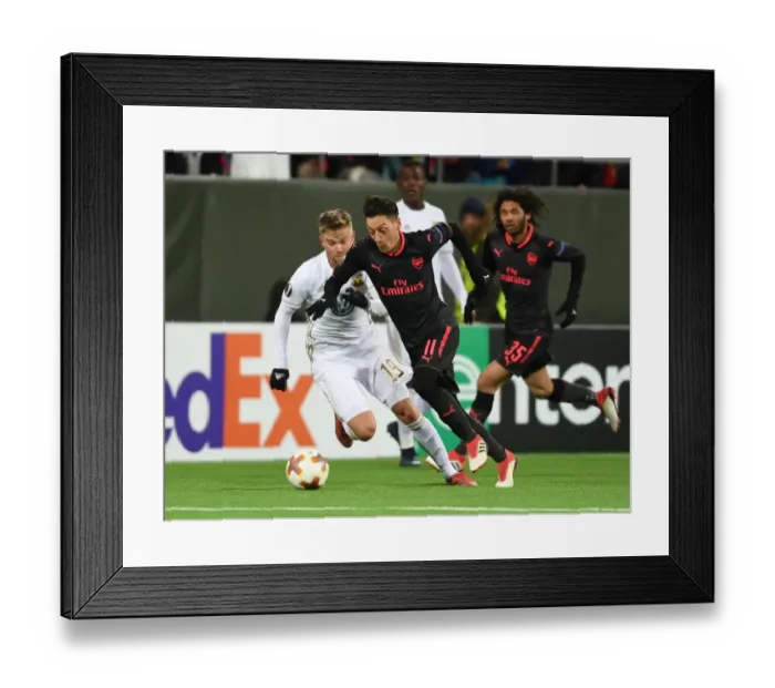 Framed Print : Mesut Ozil vs. Dennis Widgren: Clash in the Europa League between Ostersunds and Arsenal Framed Print : Mesut Ozil vs. Dennis Widgren: Clash in the Europa League between Ostersunds and Arsenal