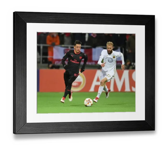 Framed Print : Mesut Ozil vs. Curtis Edwards: Arsenal's Europa League Clash with Ostersunds FK Framed Print : Mesut Ozil vs. Curtis Edwards: Arsenal's Europa League Clash with Ostersunds FK