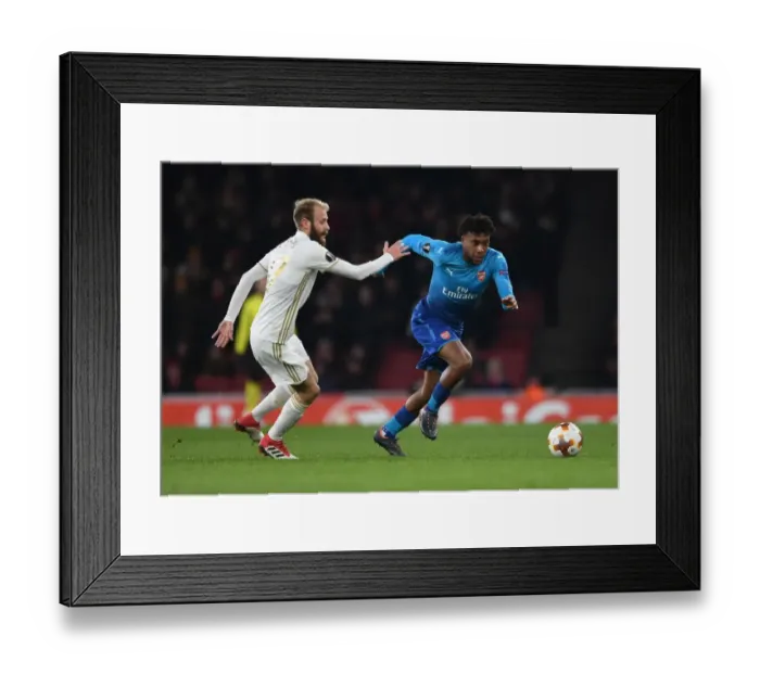 Framed Print : Arsenal's Alex Iwobi Faces Off Against Östersunds Curtis Edwards in Europa League Clash Framed Print : Arsenal's Alex Iwobi Faces Off Against Östersunds Curtis Edwards in Europa League Clash