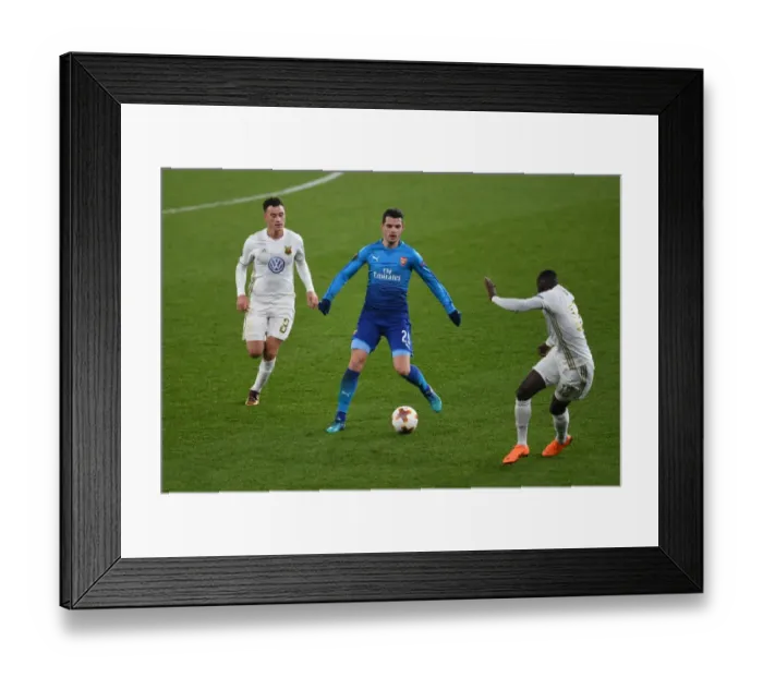 Framed Print : Xhaka vs Hopcutt: A Fight for Control in Arsenal's Europa League Clash against Östersunds FK