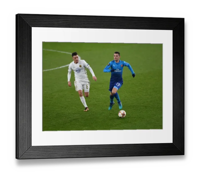 Framed Print : Granit Xhaka vs Jamie Hopcutt: Arsenal's Battle in Europa League Match against Östersunds FK Framed Print : Granit Xhaka vs Jamie Hopcutt: Arsenal's Battle in Europa League Match against Östersunds FK