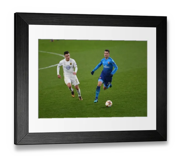 Framed Print : Xhaka vs Hopcutt: A Battle for Midfield Supremacy in Arsenal's Europa League Clash against Östersunds FK