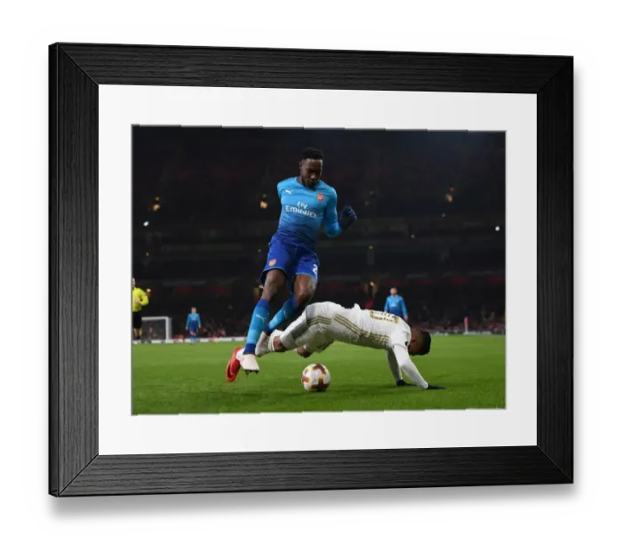 Framed Print : Arsenal's Danny Welbeck Faces Off Against Östersunds Hosam Aiesh in Europa League Clash