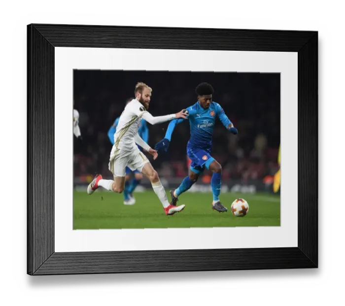Framed Print : Arsenal vs. Östersunds FK: Ainsley Maitland-Niles vs. Curtis Edwards Clash in Europa League