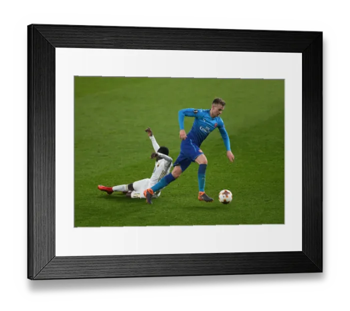 Framed Print : Arsenal's Rob Holding Clashes with Östersunds Frank Arhin in Europa League Showdown