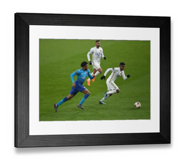Framed Print : Arsenal's Alex Iwobi Faces Off Against Östersunds Tesfaldet Tekie in Europa League Clash Framed Print : Arsenal's Alex Iwobi Faces Off Against Östersunds Tesfaldet Tekie in Europa League Clash