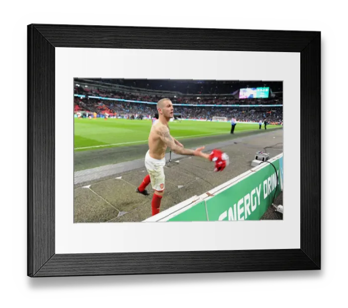 Framed Print : Jack Wilshere (Arsenal) throws his shirt to a fan after the match