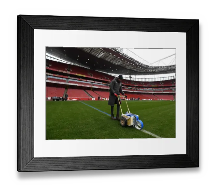 Framed Print : Arsenal Grounds Team Prepares Blue Turf for Arsenal vs Manchester City (2017-18)