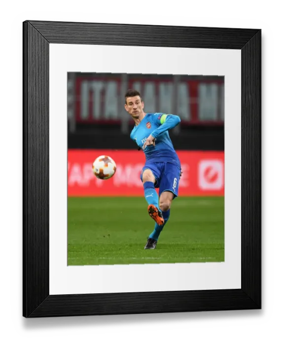Framed Print : Laurent Koscielny Focuses in AC Milan vs Arsenal Europa League Clash Framed Print : Laurent Koscielny Focuses in AC Milan vs Arsenal Europa League Clash