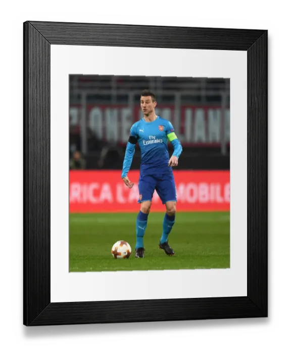 Framed Print : Focused Koscielny: Arsenal's Defensive Hero in Europa League Battle at AC Milan