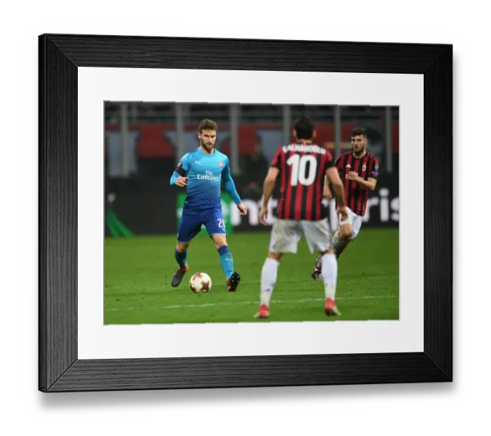 Framed Print : Shkodran Mustafi Focuses in AC Milan vs Arsenal Europa League Clash