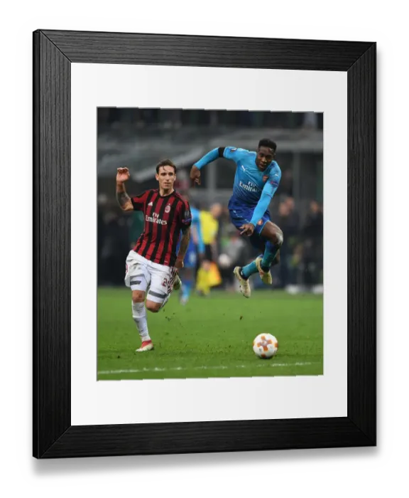 Framed Print : Danny Welbeck vs. Lucas Biglia: Clash in the UEFA Europa League Round of 16 between AC Milan and Arsenal