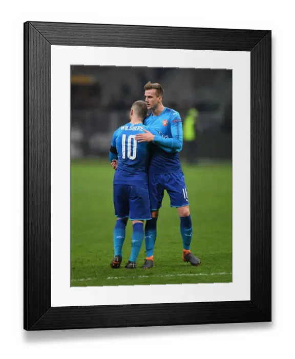 Framed Print : Camaraderie on the Field: Holding and Wilshere's Heartwarming Moment After Arsenal's Europa League Clash Against AC Milan Framed Print : Camaraderie on the Field: Holding and Wilshere's Heartwarming Moment After Arsenal's Europa League Clash Against AC Milan