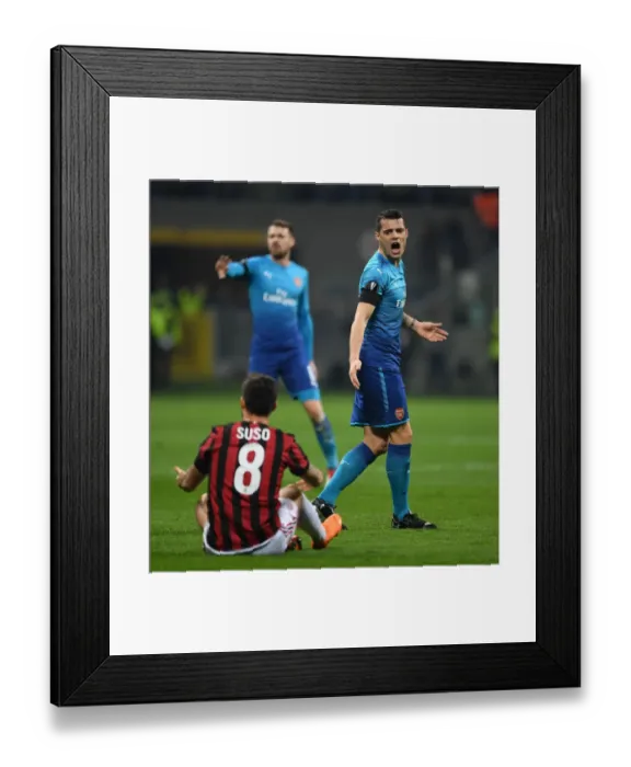 Framed Print : Xhaka vs Suso: Intense Rivalry in the UEFA Europa League Clash between AC Milan and Arsenal
